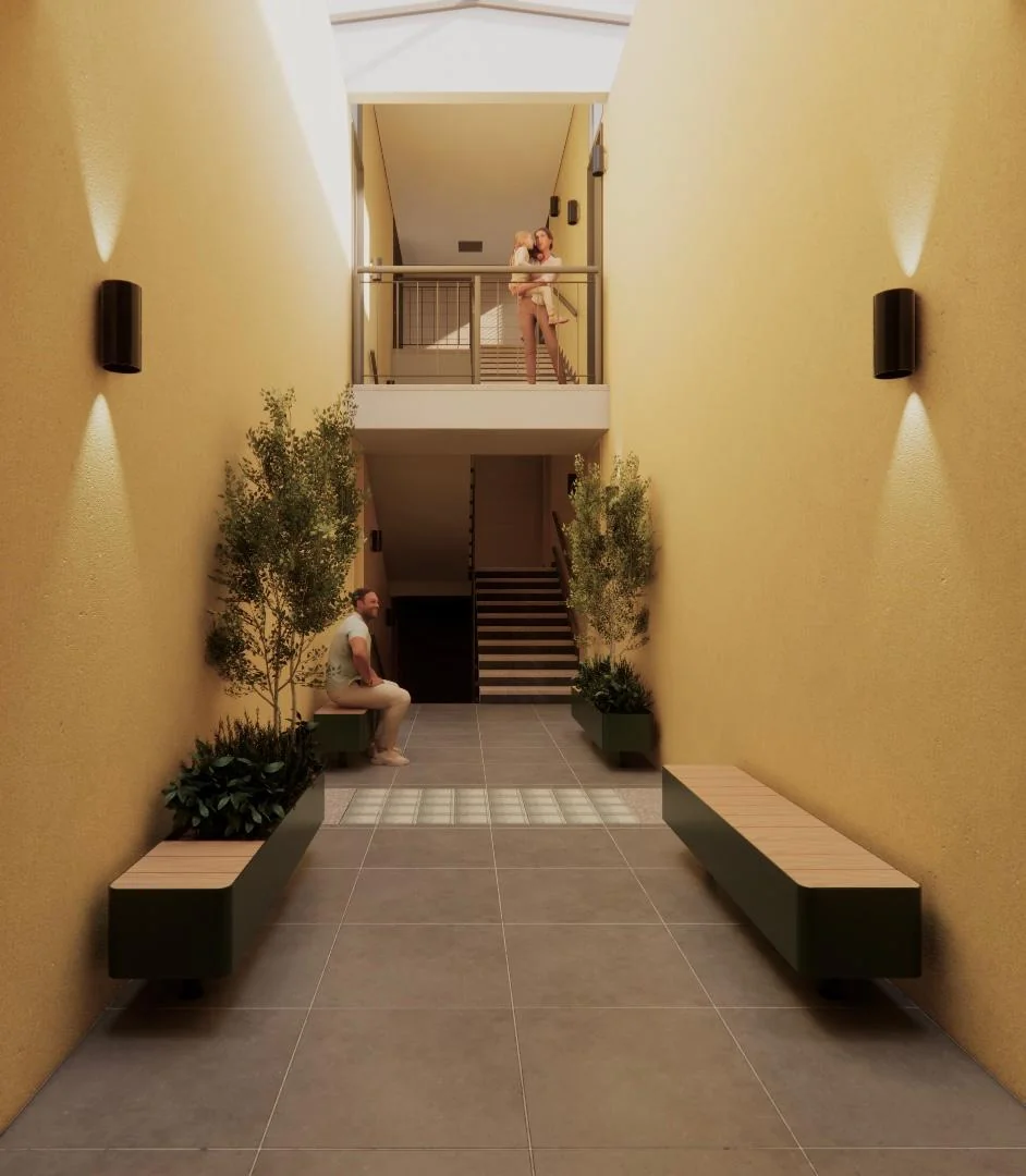 Render del andador de acceso a los departamentos, con bancas de madera, arbolitos y luz natural desde el tragaluz